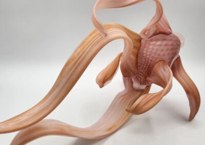 Sculpture of abstract pink and orange form.