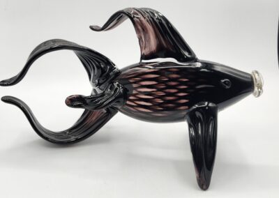 Black glass fish sculpture with curved fins.