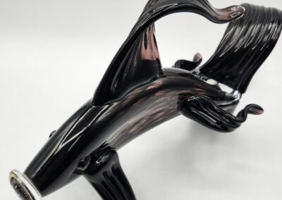 Glass sculpture resembling a stylized shark.