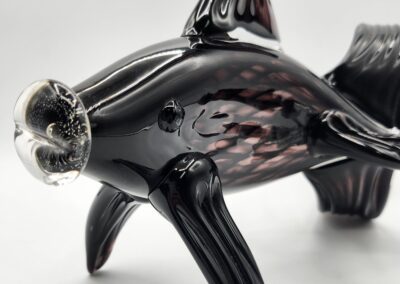 Black glass fish sculpture with transparent fins.