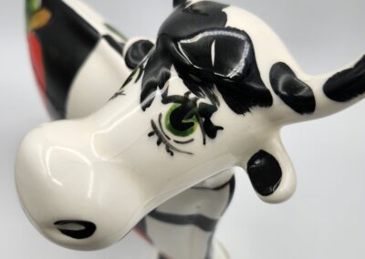 Ceramic cow figurine with painted details.