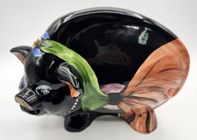 Colorful ceramic pig with abstract design.