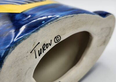 Ceramic vase base with artist's signature.