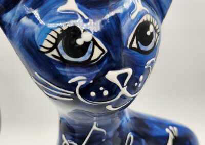 Colorful ceramic cat with musical notes design.