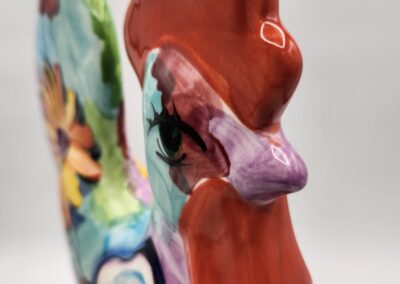 Colorful ceramic rooster with floral design.