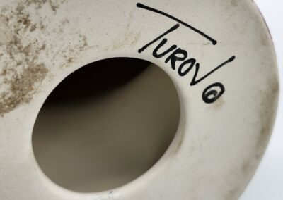 Bottom of ceramic piece with signature.