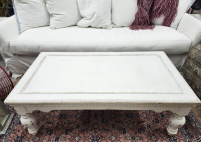 White coffee table in front of sofa.