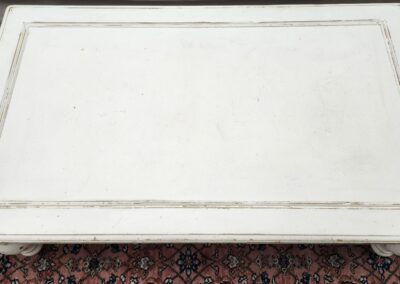 White rectangular table on patterned rug.