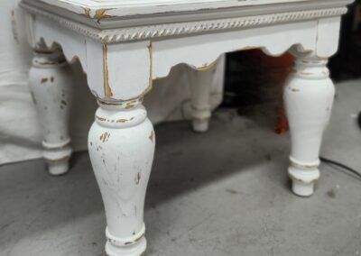 White vintage wooden table with distressed finish.