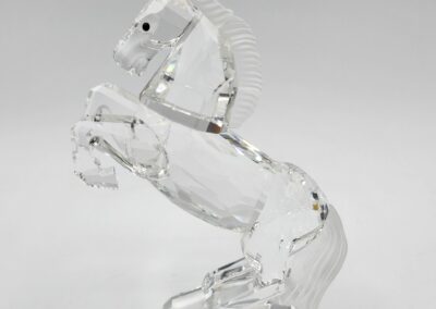 Crystal horse figurine on white background.