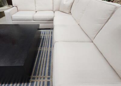 White sectional sofa in living room setting.