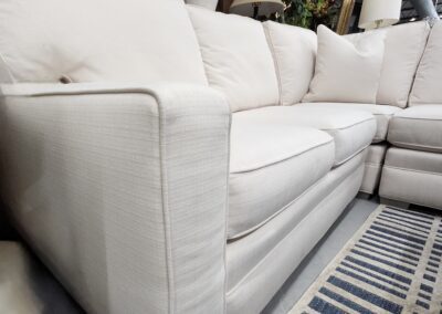 Beige sectional sofa in a showroom.