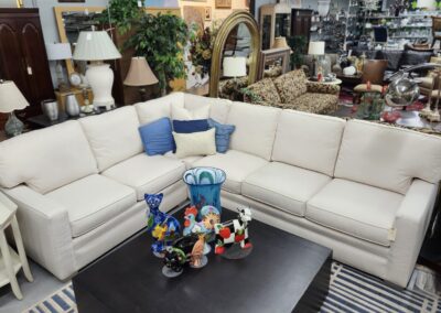 Thrift store with white couch and decor.