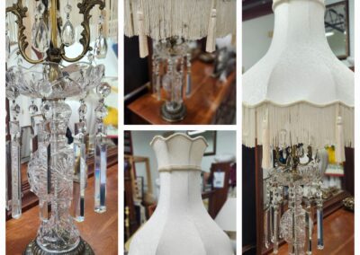 Vintage crystal lamp with ornate white shade.