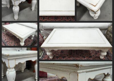 White vintage coffee table with ornate legs.