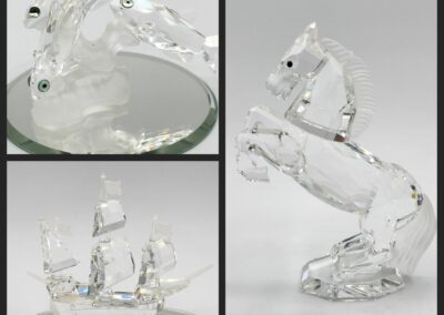 Crystal horse and ship figurines on display.