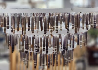 Hanging decorative feathers in a chandelier.