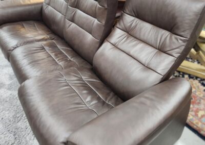 Brown leather couch in a furniture showroom.