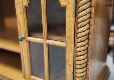 Wooden cabinet with glass door detail.