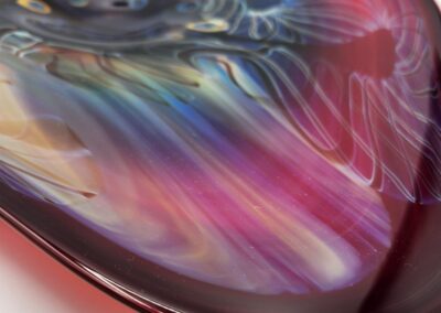 Colorful abstract glass art with swirling patterns.