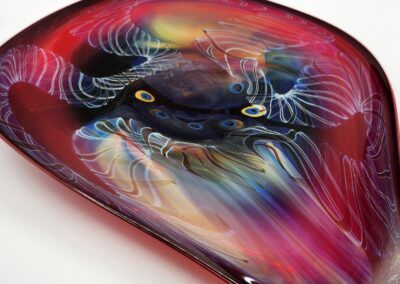 Colorful abstract glass sculpture with swirling patterns.