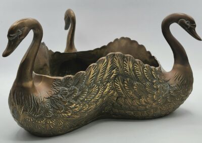 Bronze swan-shaped decorative container with details.