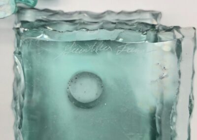 Stacked glass squares with wavy edges.