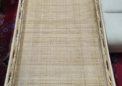Wicker tray on colorful patterned carpet.