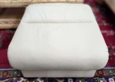 White ottoman on a patterned rug.