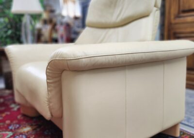 Cream leather chair on patterned rug.