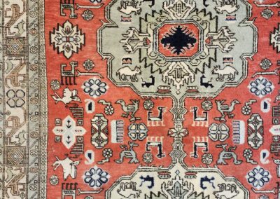 Colorful patterned rug with shoes visible below.