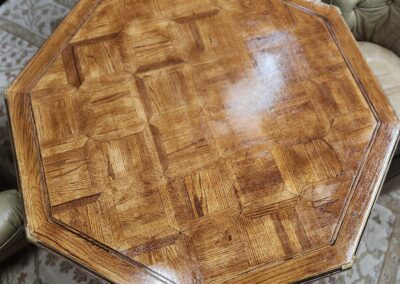 Octagonal wooden table with intricate design.