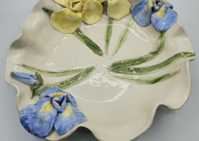 Ceramic plate with blue and yellow flowers.