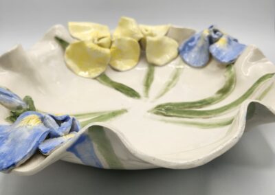 Ceramic plate with blue and yellow flowers.