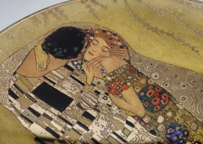 Artistic depiction of couple embracing in gold.