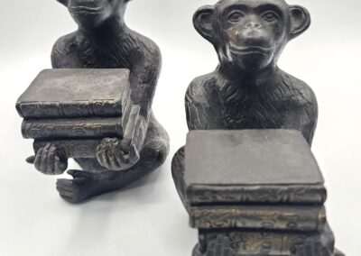 Monkey statues holding stacks of books.
