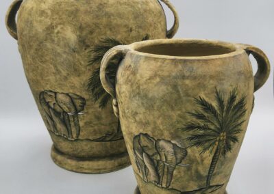 Elephant-decorated vases with palm trees.