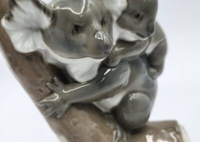 Ceramic koalas on a tree branch sculpture.