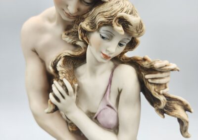 Romantic couple sculpture with flowing hair.