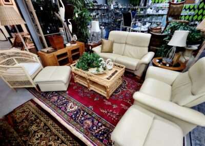 Living room with beige furniture and rugs.