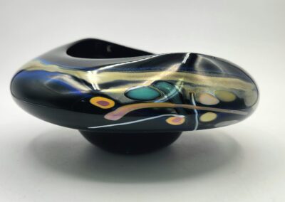 Abstract glass sculpture with colorful patterns.