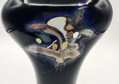 Abstract black vase with colorful patterns.