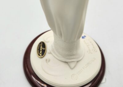 Sculpture base with engraved text and plaque.