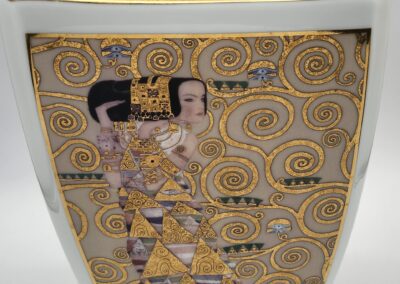 Decorative vase with intricate golden swirl design.