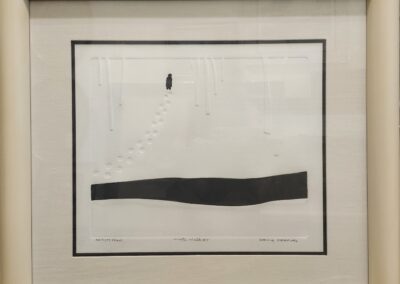 Abstract artwork with black shapes in frame.