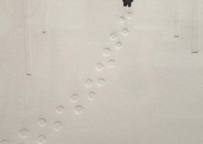 Person walking on snow with footprints.