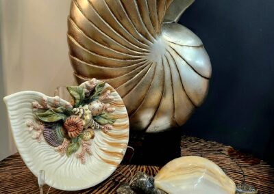 Decorative seashell and turtle sculptures on table.
