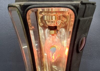 Vintage streetlight with illuminated bulb.