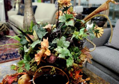 Autumn floral arrangement with candles and vase.