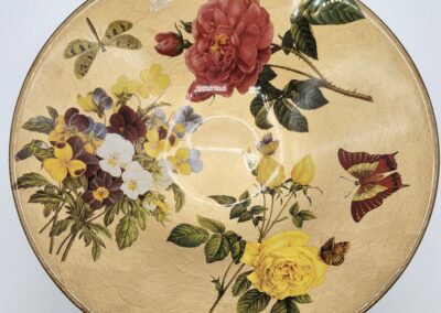 Decorative plate with flowers and butterflies design.